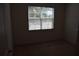 A bright bedroom featuring neutral carpeting and a sunny window at 245 Brunswick Dr, Davenport, FL 33837