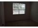A bright bedroom featuring neutral carpeting and a sunny window at 245 Brunswick Dr, Davenport, FL 33837