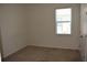Bedroom featuring neutral carpet, base trim, painted walls, and a window at 245 Brunswick Dr, Davenport, FL 33837