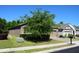 View of the side of the home showing the two-car garage and landscaping at 245 Brunswick Dr, Davenport, FL 33837