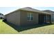 The backyard features a screened in porch. The exterior has neutral paint and a well-maintained lawn at 245 Brunswick Dr, Davenport, FL 33837