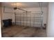 Clean two-car garage featuring concrete floors, an insulated door, and white walls at 245 Brunswick Dr, Davenport, FL 33837