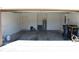 An empty two-car garage with a painted floor can be used for parking or storage at 245 Brunswick Dr, Davenport, FL 33837