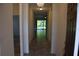 View of a neutral-colored hallway with tiled floors leading to a bright living area with a screened patio at 245 Brunswick Dr, Davenport, FL 33837