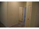 Hallway featuring tile flooring, base trim, doors, and painted walls at 245 Brunswick Dr, Davenport, FL 33837