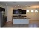 Spacious kitchen with black cabinets, stainless appliances, granite counters, and large island at 245 Brunswick Dr, Davenport, FL 33837