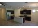 Kitchen with dark cabinets, stainless steel appliances, granite countertops, and recessed lighting at 245 Brunswick Dr, Davenport, FL 33837