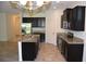 Modern kitchen with stainless steel appliances, granite countertops, and dark cabinetry offers style and functionality at 245 Brunswick Dr, Davenport, FL 33837