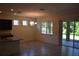 Open-concept living space with tile floors, chandelier, and sliding glass doors to the patio at 245 Brunswick Dr, Davenport, FL 33837