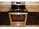 Stainless steel oven with sleek cooktop and granite countertops shows modern kitchen appliances at 245 Brunswick Dr, Davenport, FL 33837