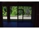 Screened-in patio offering serene views of the lush backyard greenery and natural light at 245 Brunswick Dr, Davenport, FL 33837