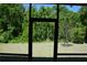 View from the screened porch looking out to the backyard and treeline at 245 Brunswick Dr, Davenport, FL 33837