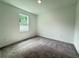 Neutral bedroom offers a calm setting with soft carpet and a bright window at 2531 Blue Wave Pl, Oviedo, FL 32765