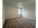 Simple bedroom with carpeted floors, a window, and a minimalist design at 2531 Blue Wave Pl, Oviedo, FL 32765