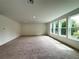 Bright bonus room with plush carpet and large windows at 2531 Blue Wave Pl, Oviedo, FL 32765
