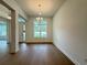 Bright dining room featuring hardwood floors and an elegant chandelier, perfect for Gathering gatherings at 2531 Blue Wave Pl, Oviedo, FL 32765