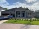 An exterior shot of a single-story home, landscaped yard, and a brick driveway at 2531 Blue Wave Pl, Oviedo, FL 32765