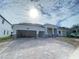 Charming single-story home featuring a three-car garage and attractive stone accents on the facade at 2531 Blue Wave Pl, Oviedo, FL 32765