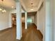 Open-concept hallway with hardwood floors providing a view to the kitchen and outdoor living area at 2531 Blue Wave Pl, Oviedo, FL 32765