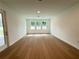 Bright living room with hardwood floors and multiple windows providing natural light at 2531 Blue Wave Pl, Oviedo, FL 32765