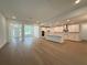 Bright, open living space featuring new flooring and a kitchen with white cabinets and stainless appliances at 2531 Blue Wave Pl, Oviedo, FL 32765