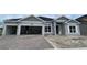 Charming single-story home with a two-car garage and brick paver driveway is waiting for landscaping at 2643 Ravencliffe Ter, Oviedo, FL 32765