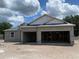 Under-construction exterior showcasing block home with attached two-car garage and partially completed roof at 2644 Ravencliffe Ter, Oviedo, FL 32765