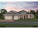 Charming single Gathering home features a spacious three car garage, neutral paint, and professionally landscaped yard at 2644 Ravencliffe Ter, Oviedo, FL 32765