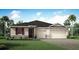 Charming single-story home with stone accents, a three-car garage, and lush landscaping at 2774 Sweet Acacia Dr, Clermont, FL 34711