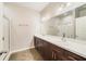 A bathroom features double sinks, a large mirror, and a glass door shower at 2792 Whispering Trails Dr, Winter Haven, FL 33884