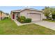 Charming single-story home with well-maintained landscaping and a two-car garage at 2792 Whispering Trails Dr, Winter Haven, FL 33884