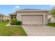 Well-maintained single-story home with a two-car garage and manicured lawn at 2792 Whispering Trails Dr, Winter Haven, FL 33884