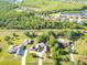 Aerial view showcasing the home, lush landscaping, and the surrounding neighborhood at 2836 S Stewart St, Kissimmee, FL 34746