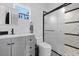 Modern bathroom with a sleek vanity, toilet, and enclosed glass shower showcasing elegant marble accents at 2836 S Stewart St, Kissimmee, FL 34746