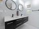 Modern bathroom with double sinks, sleek black hardware, and marble-style tile at 2836 S Stewart St, Kissimmee, FL 34746