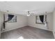 Bedroom with wood-look vinyl floors, ceiling fan, and two windows at 2836 S Stewart St, Kissimmee, FL 34746