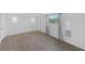 Spacious bedroom with a large window offering natural light and neutral-toned walls and wood flooring at 2836 S Stewart St, Kissimmee, FL 34746