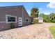 Charming home exterior featuring a brick driveway, a palm tree, and a welcoming front entrance at 2836 S Stewart St, Kissimmee, FL 34746