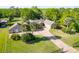 Front yard features mature palms, brick paved driveway and black fencing at 2836 S Stewart St, Kissimmee, FL 34746