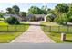Spacious property features a long brick driveway and lush green lawn at 2836 S Stewart St, Kissimmee, FL 34746