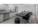 Bright kitchen featuring an island with bar seating, granite counters, and stainless steel appliances at 2836 S Stewart St, Kissimmee, FL 34746