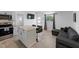 Bright living room with modern kitchen appliances and eat-in bar seating, and cozy sofa at 2836 S Stewart St, Kissimmee, FL 34746