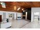 Bright living room with vaulted wood ceilings, skylights, and tiled floors at 2836 S Stewart St, Kissimmee, FL 34746