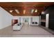 Spacious living room with wooden ceiling, fireplace, tile flooring, and access to a backyard view at 2836 S Stewart St, Kissimmee, FL 34746