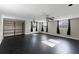 Bright living room featuring dark tile floors, ceiling fans, and large windows with dark curtains at 2836 S Stewart St, Kissimmee, FL 34746