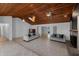 Bright living room boasts a wooden ceiling, modern sofas, tile flooring, and a cozy fireplace at 2836 S Stewart St, Kissimmee, FL 34746