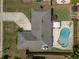Aerial view of a backyard with a swimming pool, mature landscaping, and a patio area at 3029 Peel Ave, Orlando, FL 32806