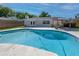 Gorgeous in-ground backyard pool with travertine patio, pergola, and home exterior at 3029 Peel Ave, Orlando, FL 32806