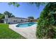 Backyard view of the lovely in-ground pool, patio and home exterior at 3029 Peel Ave, Orlando, FL 32806
