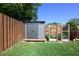 Backyard shed with garden plot on a manicured lawn with fencing at 3029 Peel Ave, Orlando, FL 32806